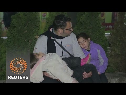 migrants line up for registration papers