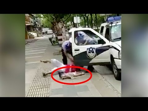 policeman throws woman holding a baby