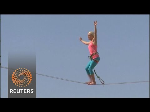 slackliner walks between towers in jerusalem