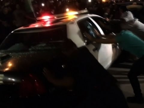protesters attack cop car after trump rally