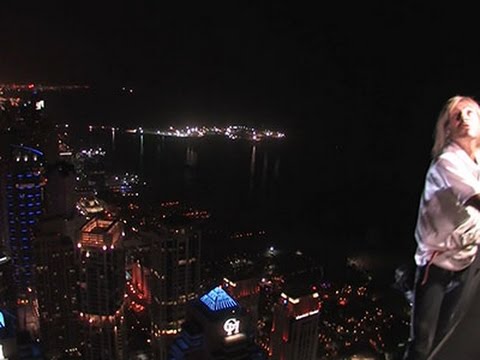 climber scales one of dubais tallest tower